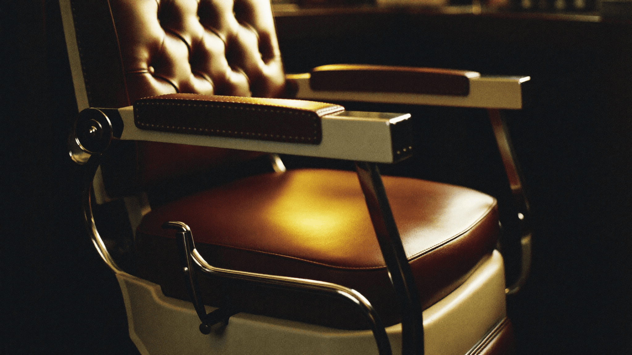 Tufted leather barber chair at Shop 13 Barber Lounge